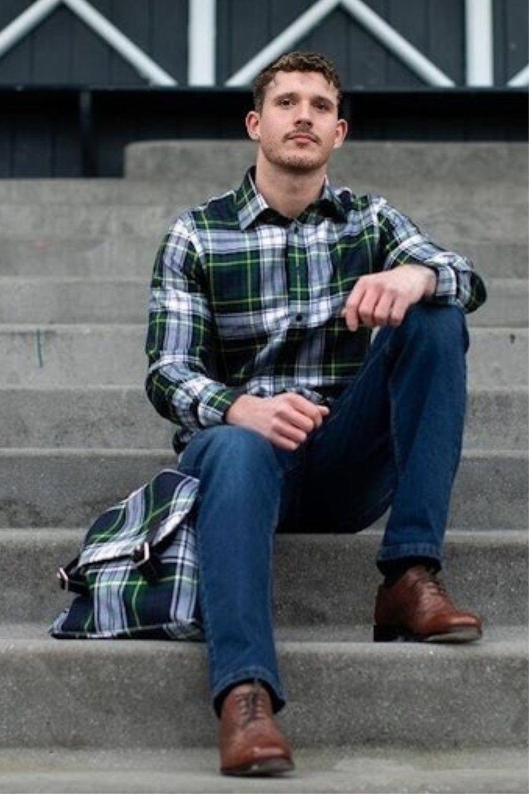 Man Holding Tartan Messenger Bag