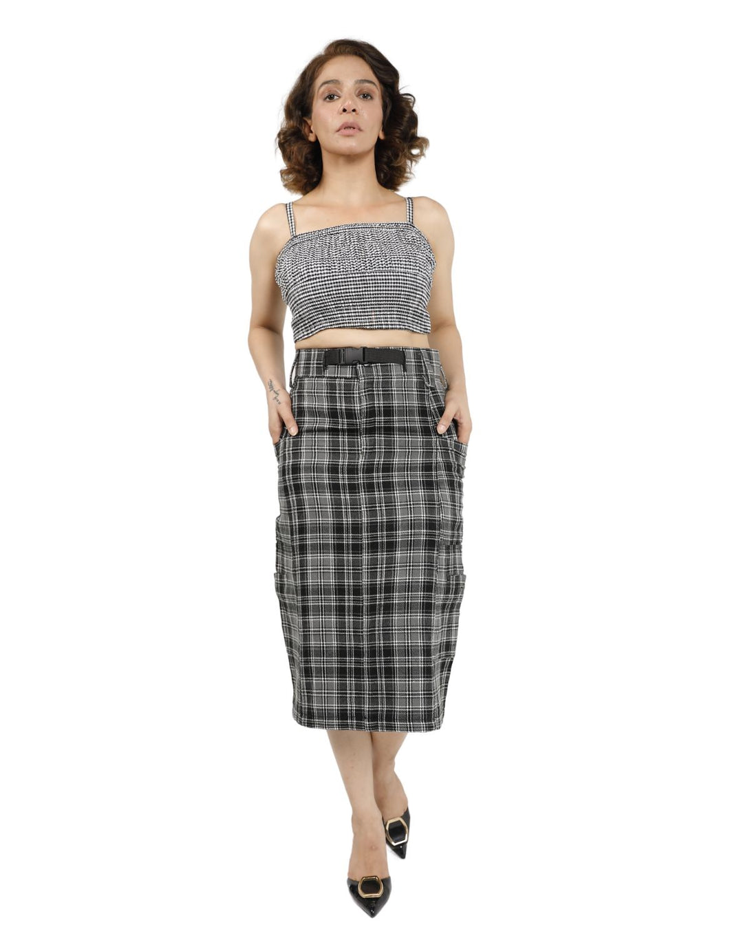 Close-up of tailored plaid pencil skirt with belt